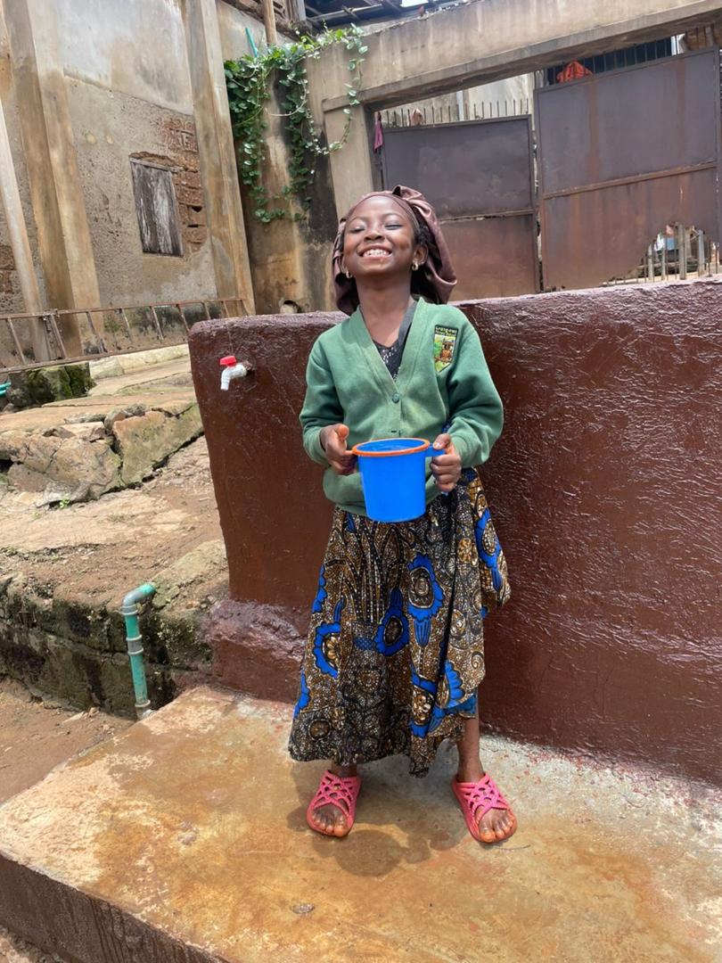 Child collecting water from the new borehole
