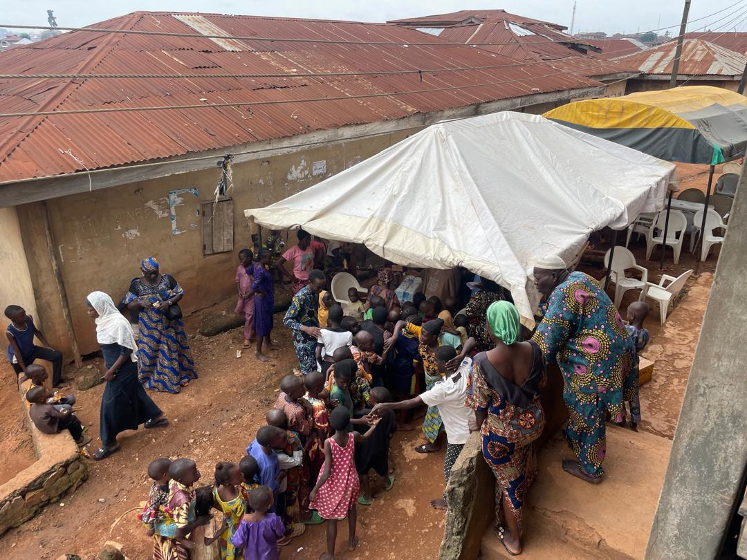 Aerial view of the outreach tents and gathering crowd among the rooftops of Atipe Oke-Offa