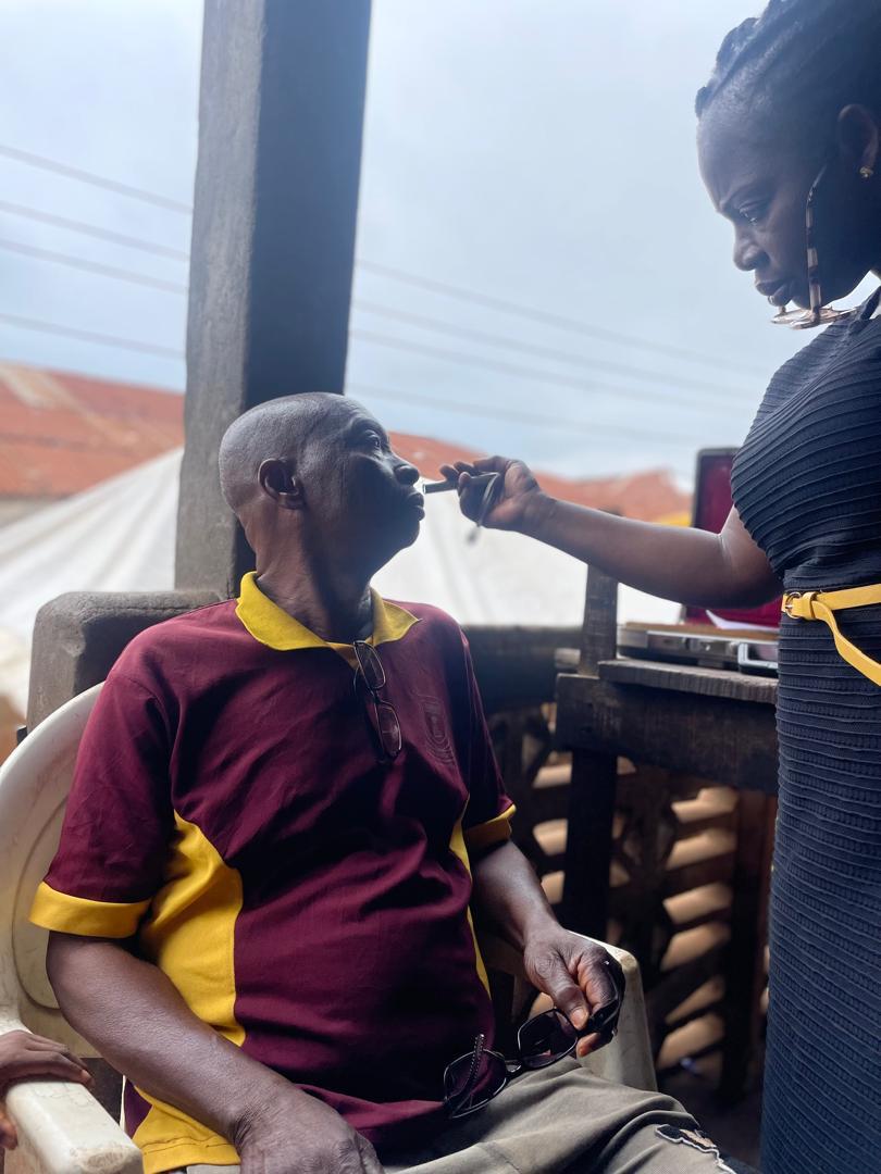 A dental volunteer examining a patient outdoors