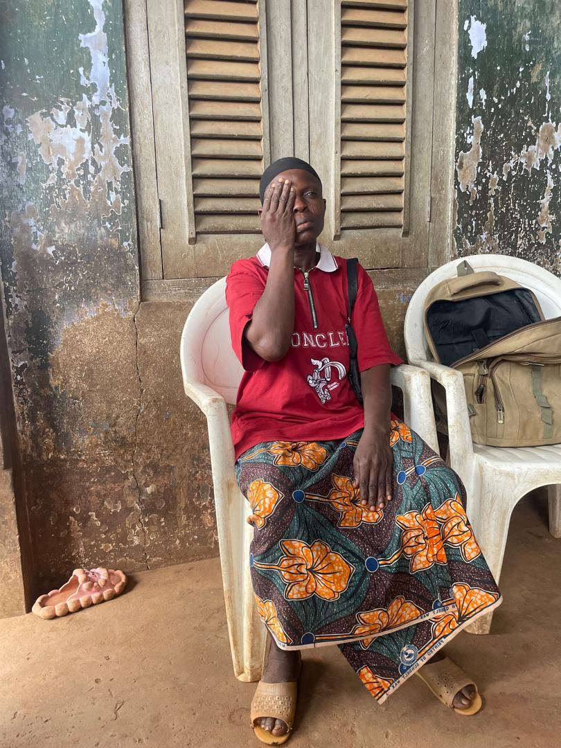 A woman testing her own vision by covering one eye